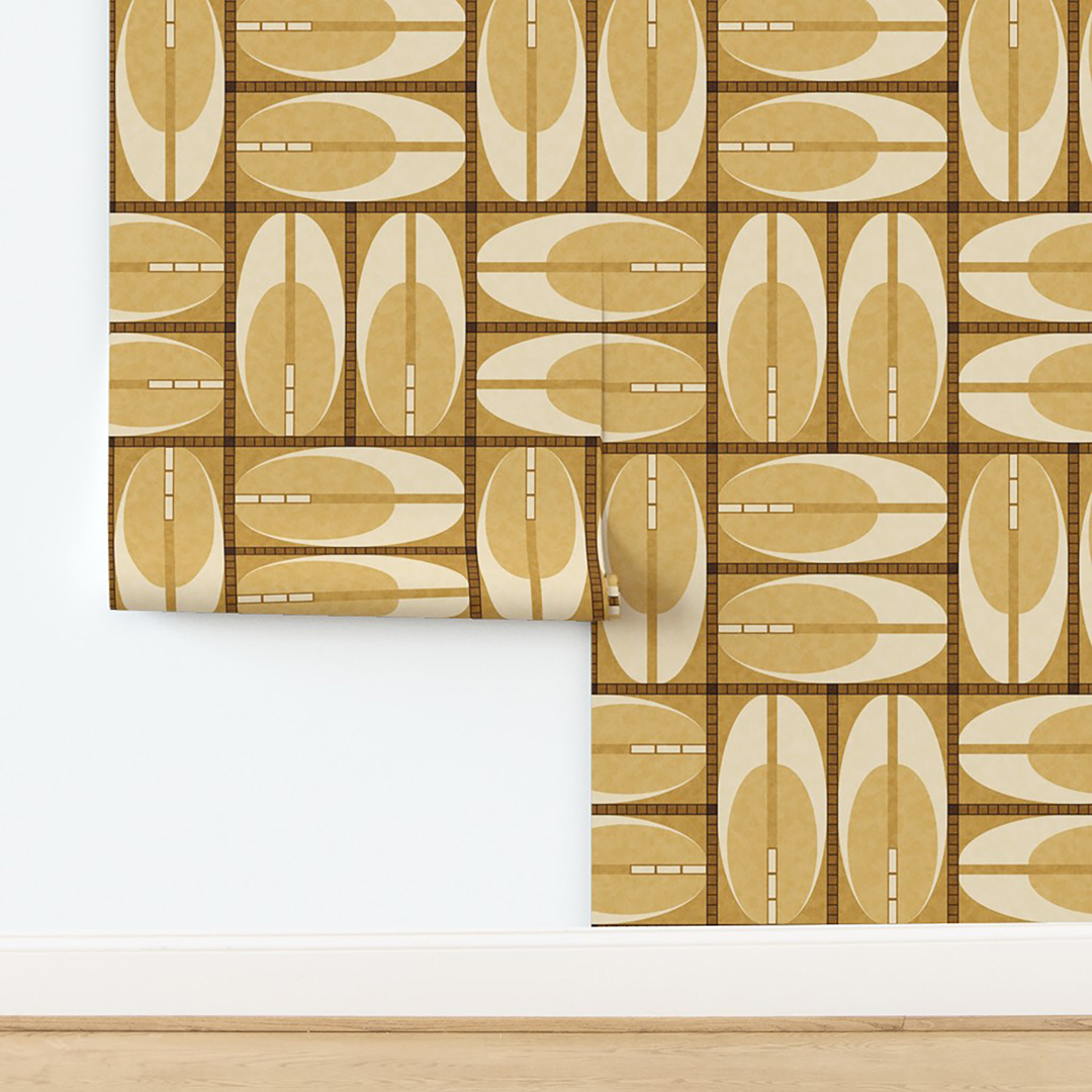 The artwork features a repeating geometric pattern of symmetrical shapes resembling elongated, curved diamonds or petals in various shades of blue and green. Each shape is split vertically with one half filled with a light blue and the other half filled with green or darker blue. The background is a light, almost pastel blue, which provides a soft yet vibrant backdrop. One of the blue shapes near the upper left contains a white starburst element, adding a focal point of brightness to the composition. The overall design conveys a modern, mid-century aesthetic with clean lines and harmonious color contrasts.